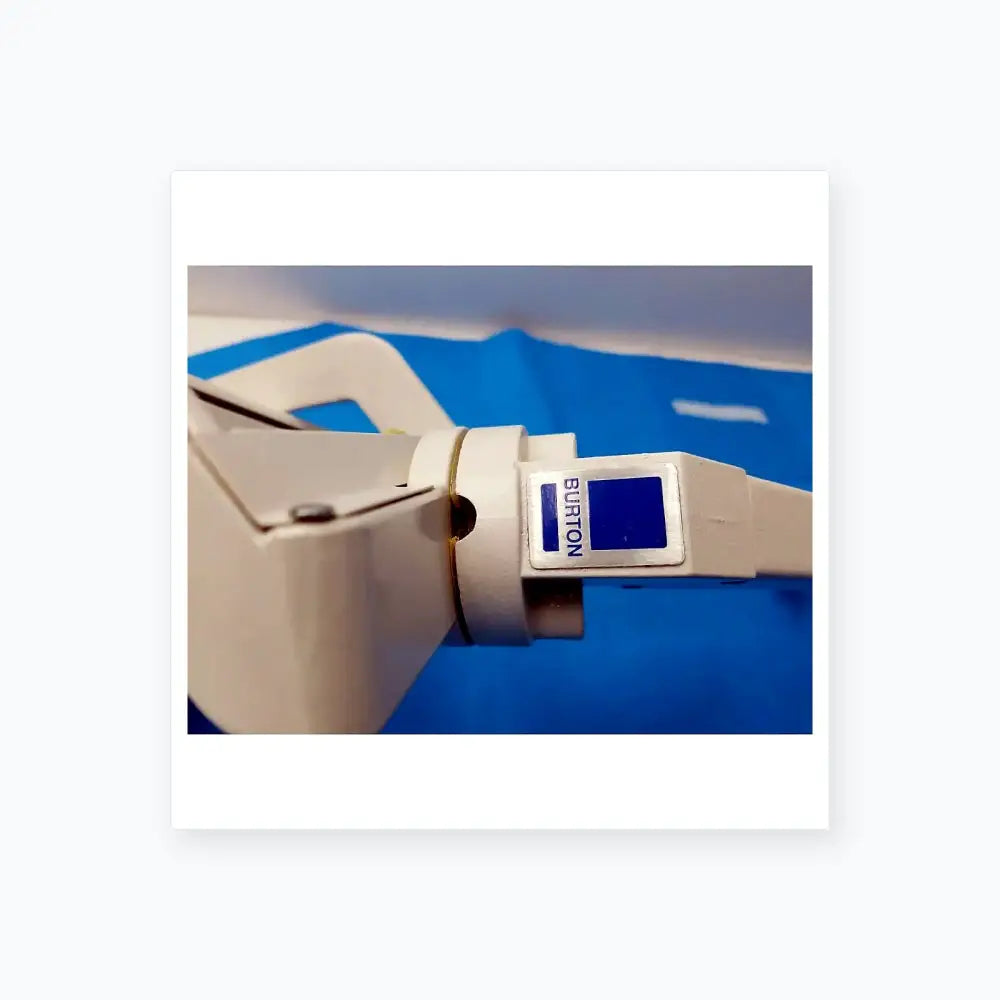 White plastic burton brand laser hair removal device with blue label and metallic accent for reuse medical equipment