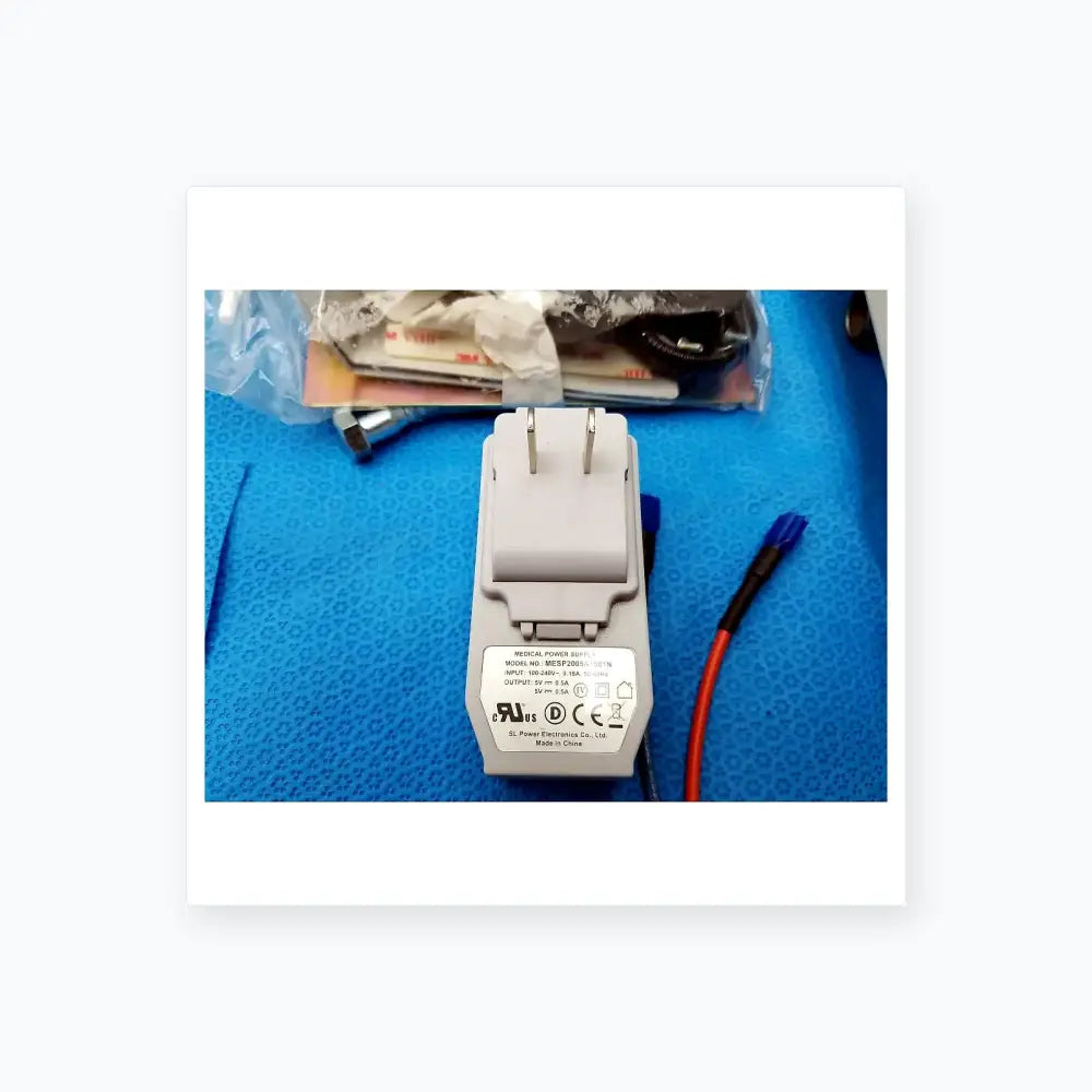 Gray plastic medical power supply adapter with model mesp2005a189in label for burton medical examination light