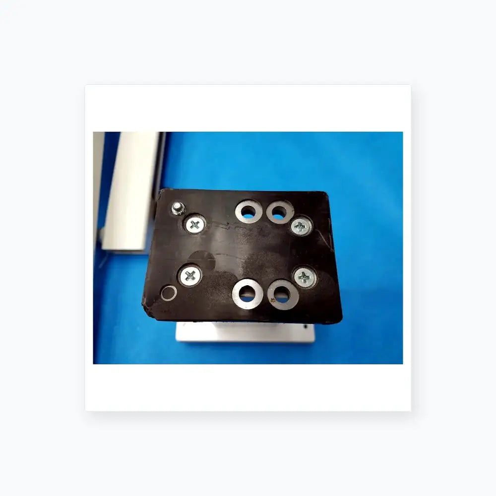 Black rectangular mounting plate with six silver screws and four washers for burton medical outpatient ii examination light wall mount assembly