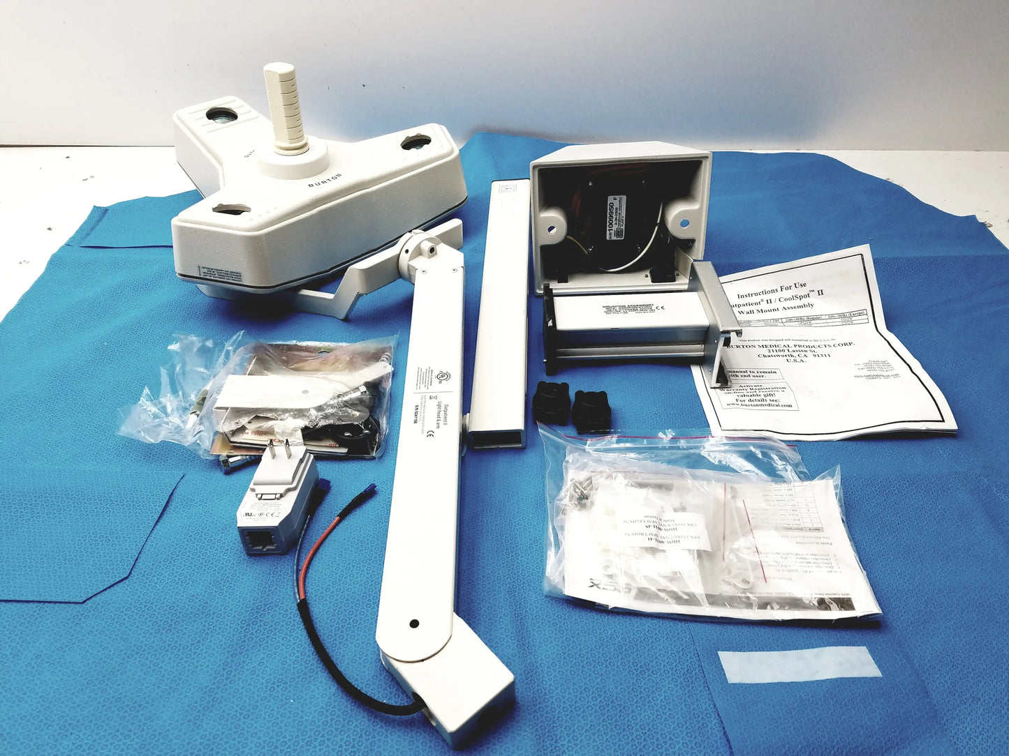 White medical examination lamp with adjustable arm and wall mount bracket for reuse medical equipment by smiths medical