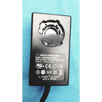 Black rectangular medical power supply adapter with metallic circular plug for Burton ultraviolet examining light 031980