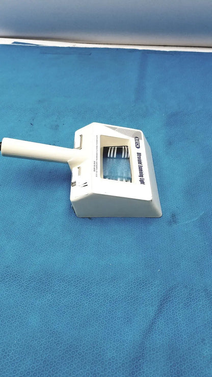 White plastic dustpan with handle and integrated brush head labeled advanced dusting tool for burton ultraviolet examining light use