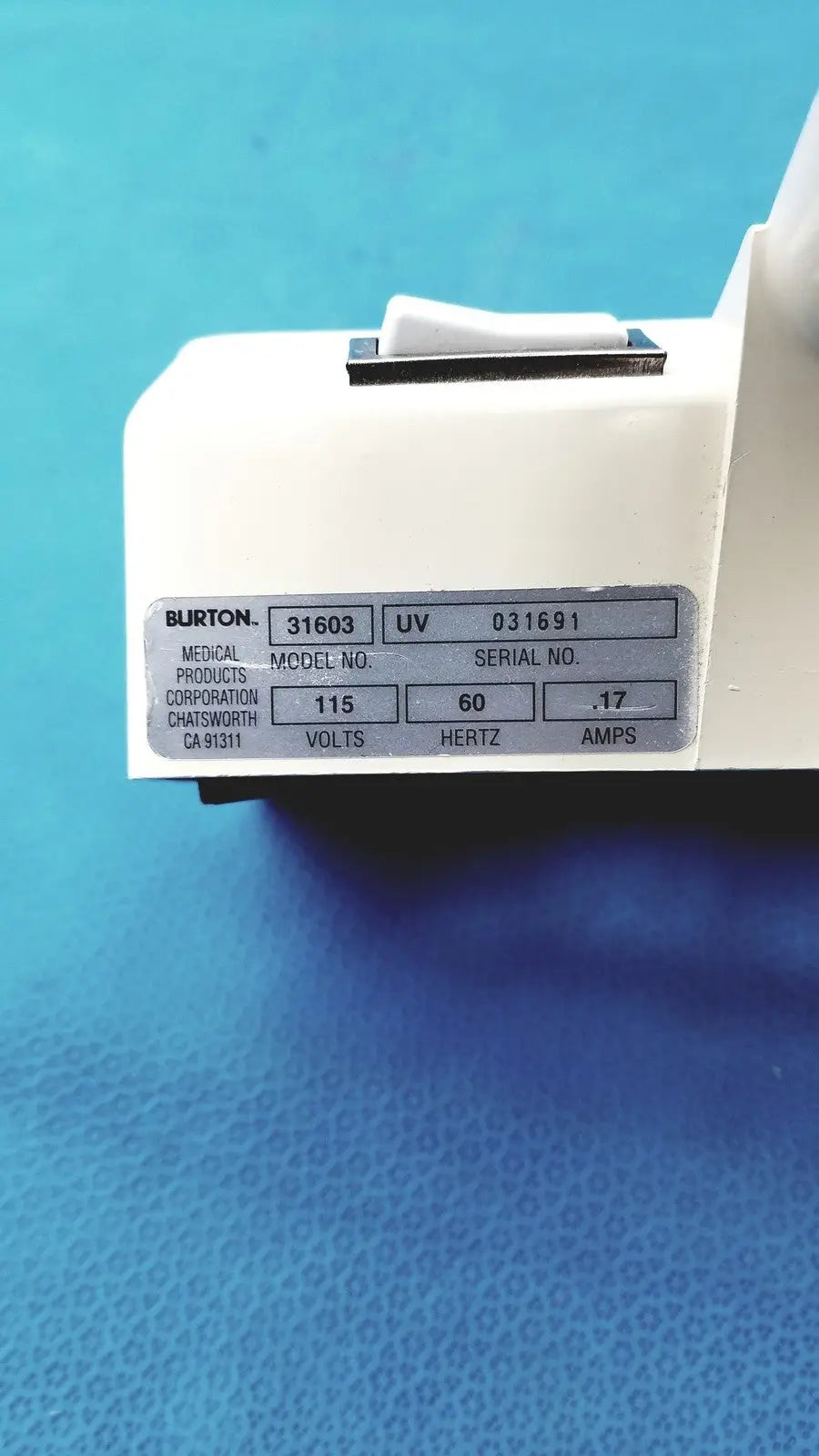 White plastic burton ultraviolet examining light model 31603 with silver technical specifications label for medical use