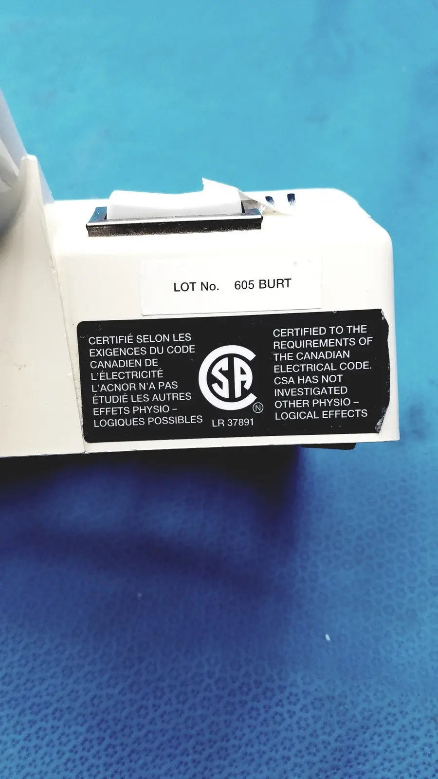White plastic burton ultraviolet examining light with black certification label and silver switch for ultraviolet examining use