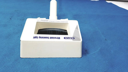 White plastic Burton ultraviolet examining light with rectangular base and vertical handle for medical use
