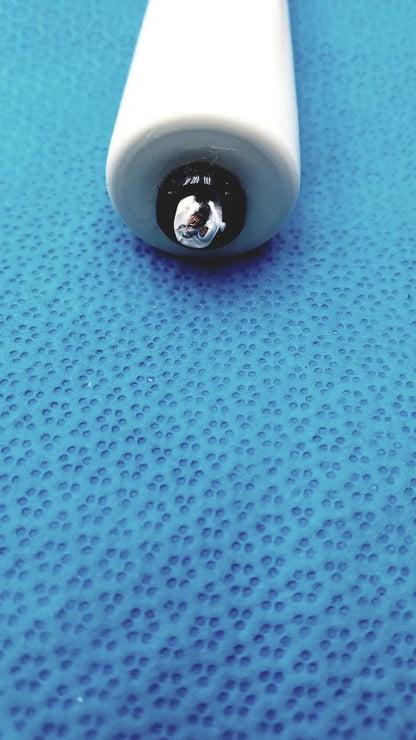 White pen with shiny metallic tip used with Burton ultraviolet examining light for precise ultraviolet examining tasks
