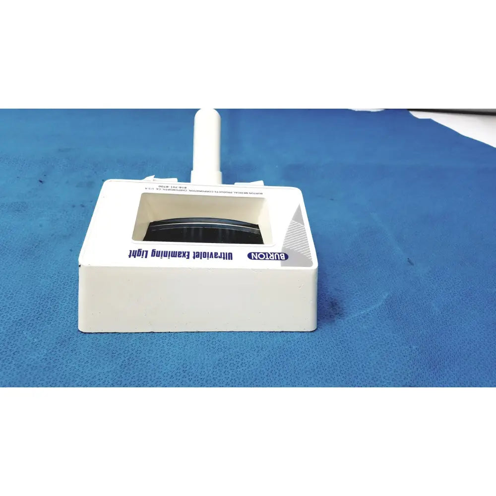 White plastic Burton ultraviolet examining light with rectangular base and vertical handle for medical use