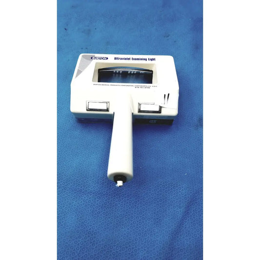 White burton ultraviolet examining light with rectangular head, black control buttons, and clear viewing window for precise use