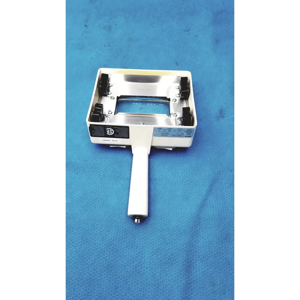 White-handled handheld magnifier with metallic silver frame and black clamps for burton ultraviolet examining light use