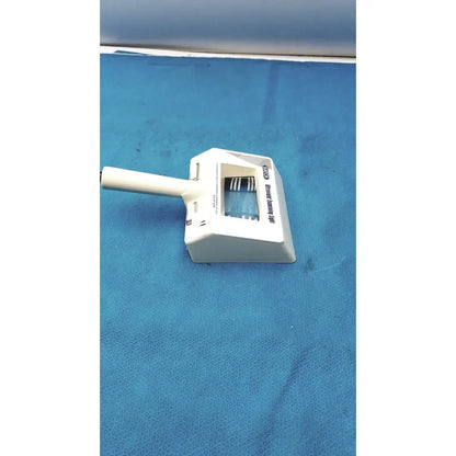 White plastic dustpan with handle and integrated brush head labeled advanced dusting tool for burton ultraviolet examining light use