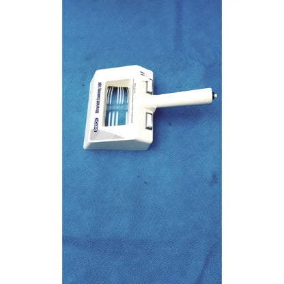 White plastic burton ultraviolet examining light with blue illuminated strips visible through transparent window