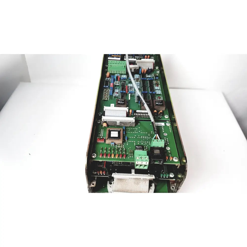 Green printed circuit board of Bystronic amplifier cno2 25a with various electronic components and a white cable
