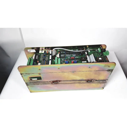 Industrial-grade green circuit board amplifier cno2 25a housed in weathered iridescent metal enclosure with mounting hardware