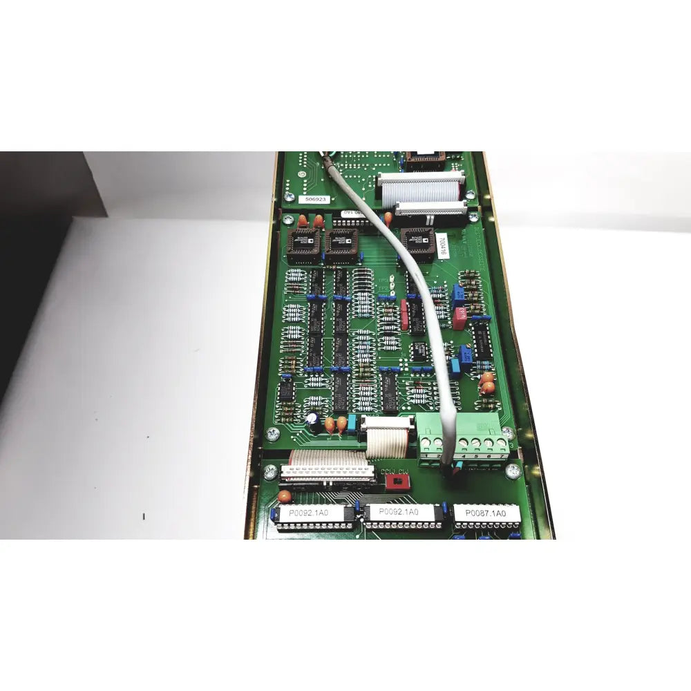 Green printed circuit board of bystronic amplifier cno2 25a with black ic, blue and red capacitors, and metallic connectors