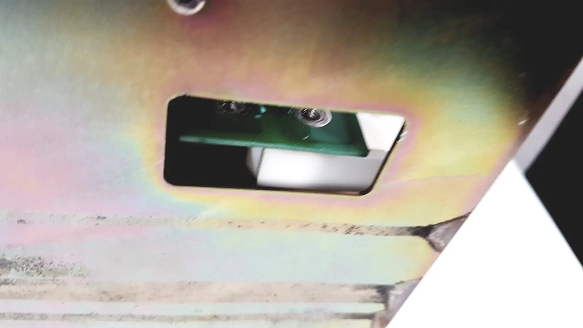 Green circuit board with two silver screws inside a metallic casing of bystronic amplifier cno2 25a 3000 rpm