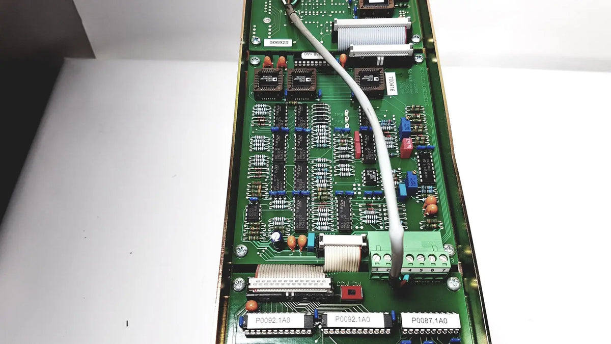 Green printed circuit board of bystronic amplifier cno2 25a with black ic, blue and red capacitors, and metallic connectors