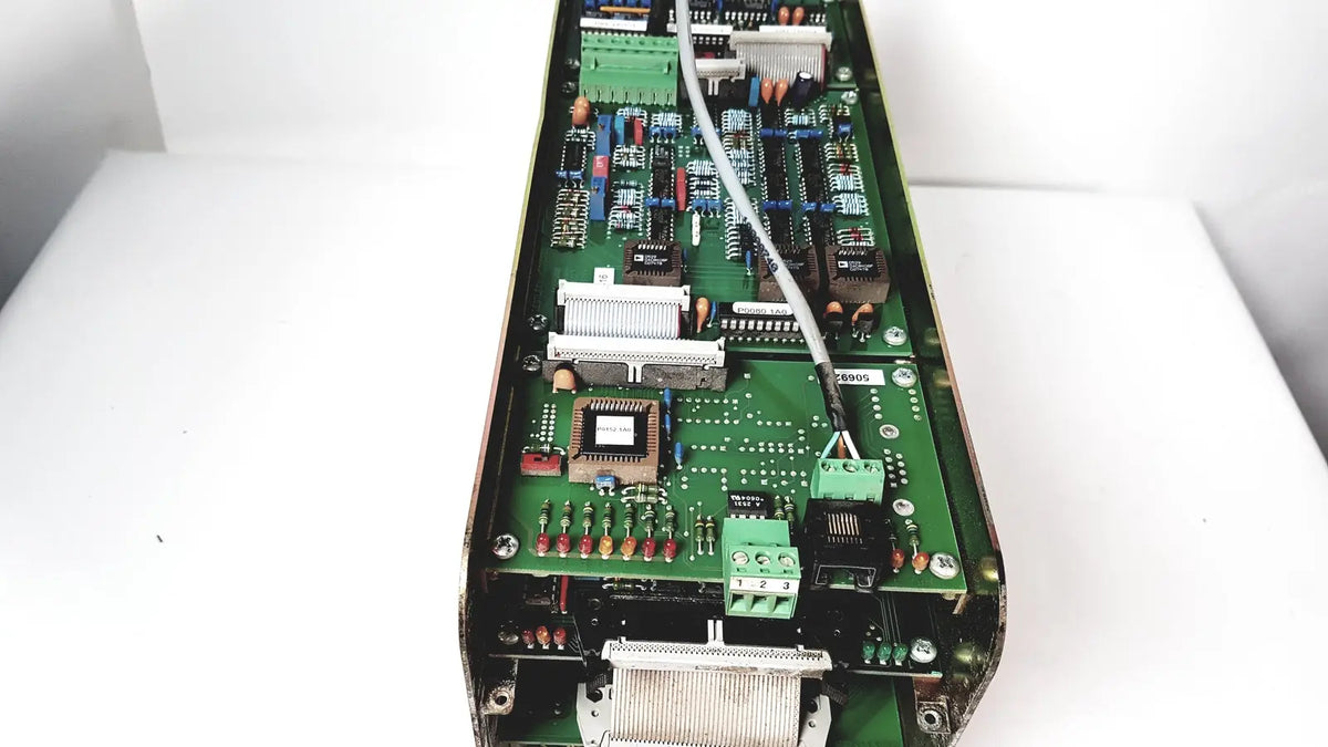 Green printed circuit board of Bystronic amplifier cno2 25a with various electronic components and a white cable