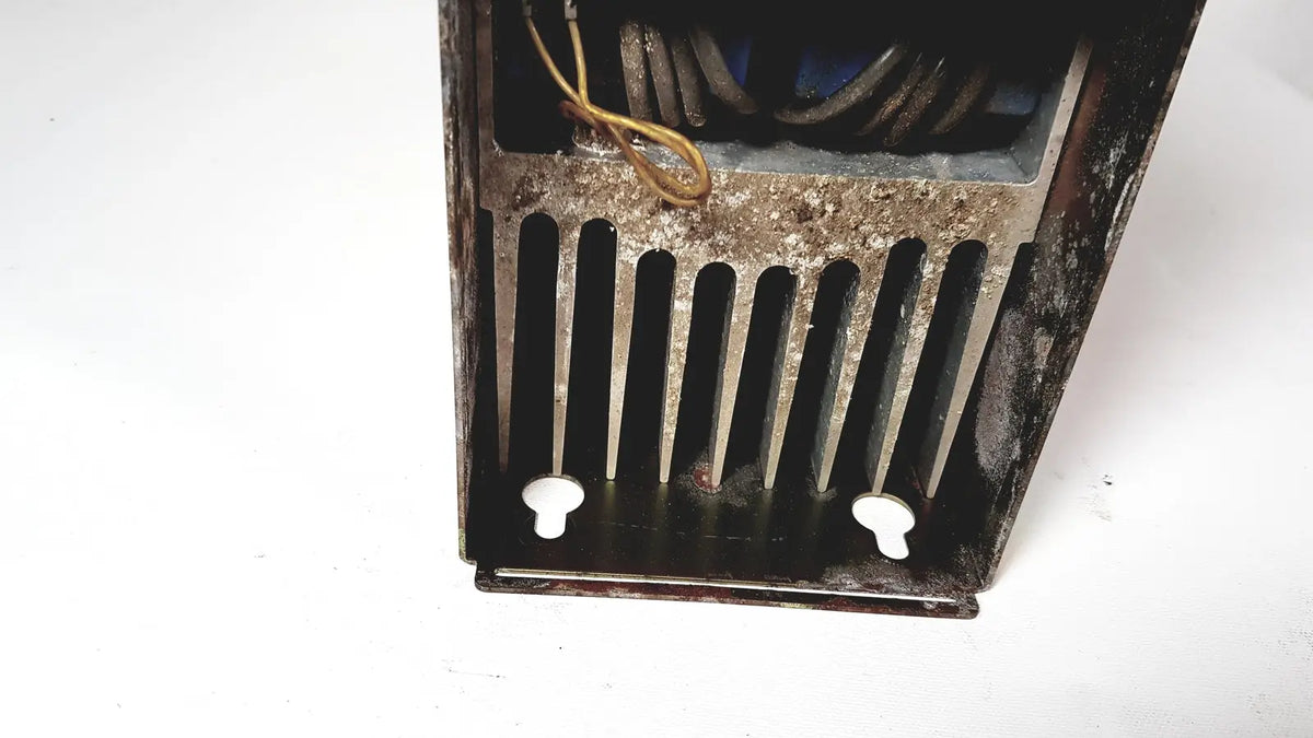 Rusty metal radiator with vertical slats and white plastic feet on the back side of bystronic amplifier cno2 25a product