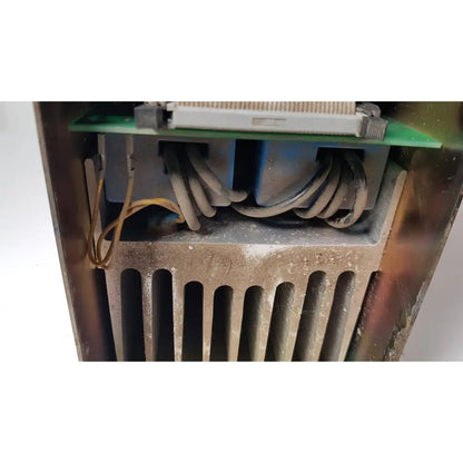 Dusty metallic Bystronic amplifier cnco2 50a radiator with vertical slats and green circuit board for reuse medical