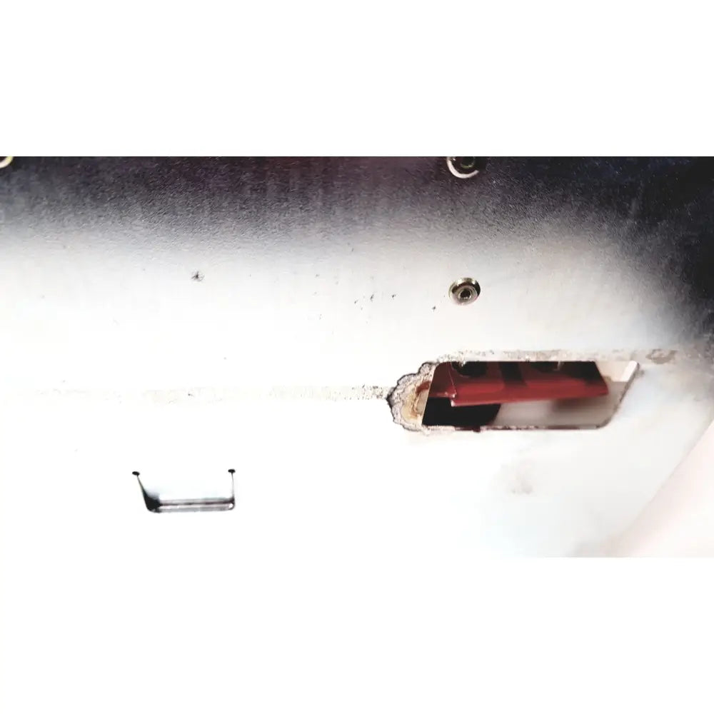 A red rectangular battery housed in a white slightly corroded metal casing of bystronic amplifier cnc02 50a product