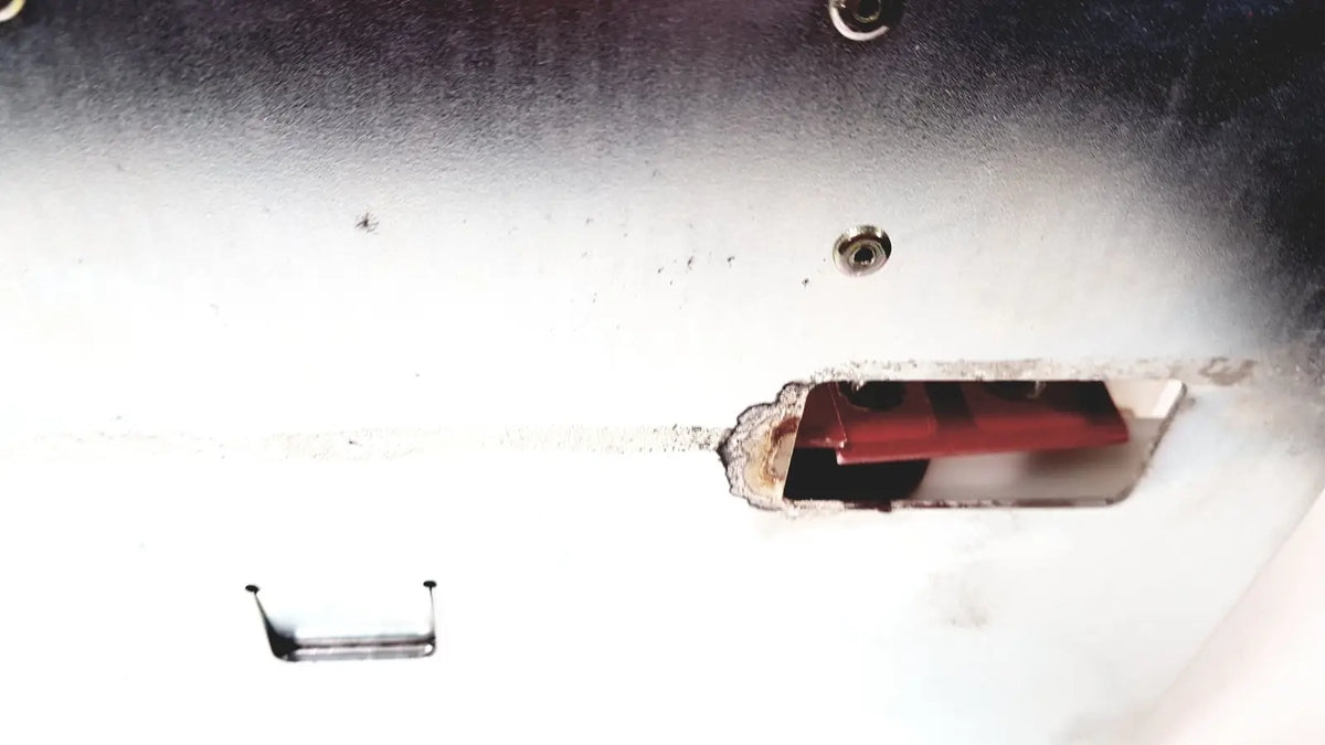 A red rectangular battery housed in a white slightly corroded metal casing of bystronic amplifier cnc02 50a product