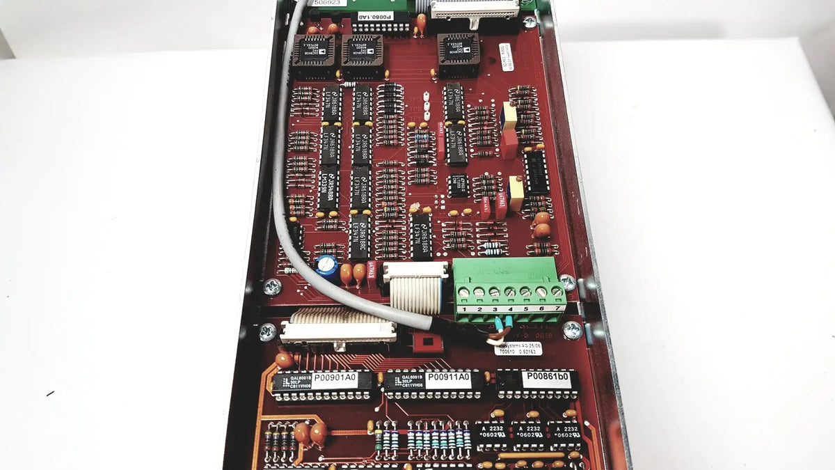 Red circuit board with black integrated circuits green terminal block and beige ribbon cable for bystronic amplifier cnc02 50a