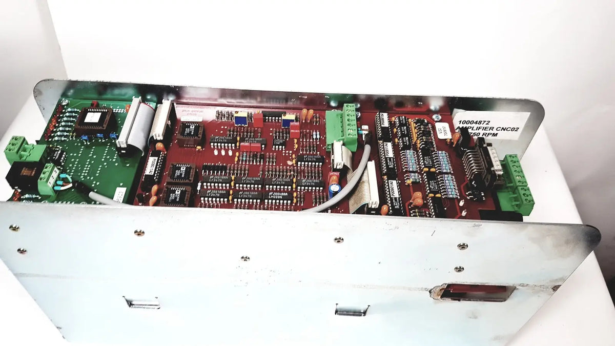 Red and green circuit board assembly housing the bystronic amplifier cnc02 50a in a white metal enclosure