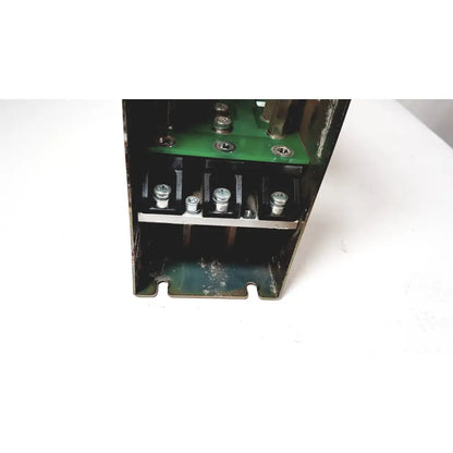 Black metal electrical enclosure showing green circuit board and silver terminal screws of bystronic module vm 50a 300v power supply