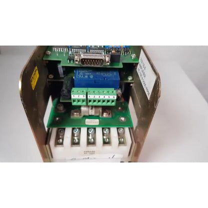 Blue bystronic 702116-a amplifier with green terminal blocks and silver d-sub connector in open metal enclosure