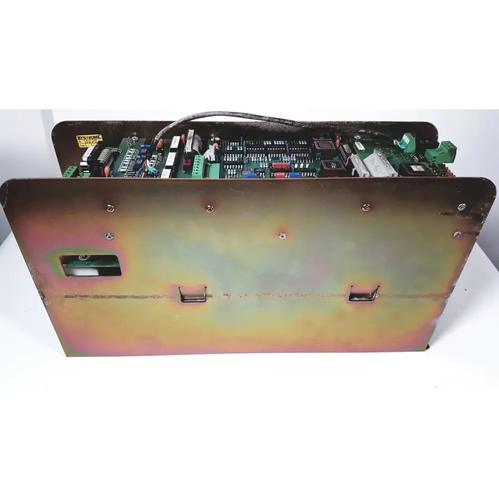 Industrial-grade metal enclosure of bystronic 702116-a amplifier with weathered iridescent finish and visible internal circuitry