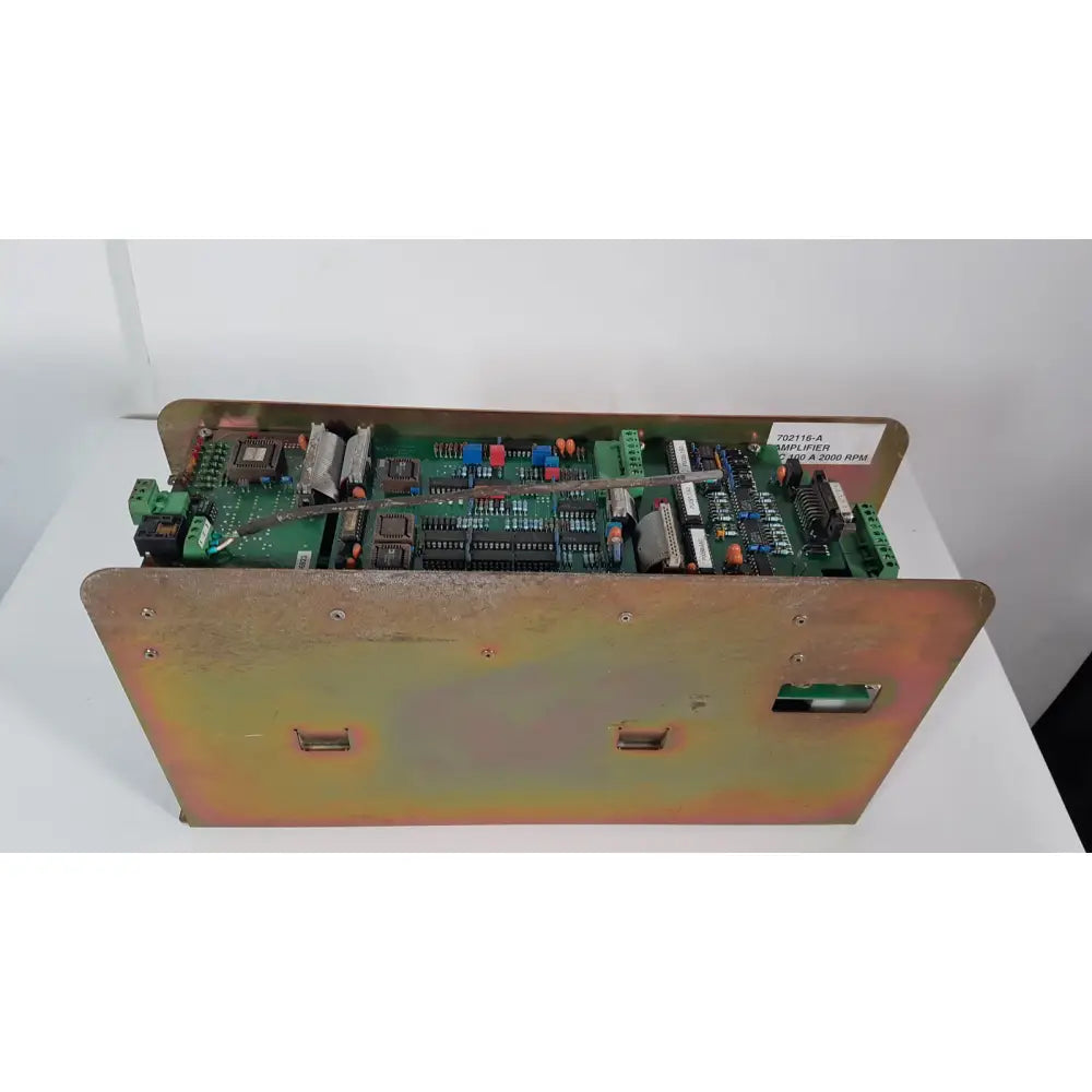 Green circuit board in rust-toned metal enclosure with screws and labels of bystronic 702116-a amplifier 100 a 2000 rpm