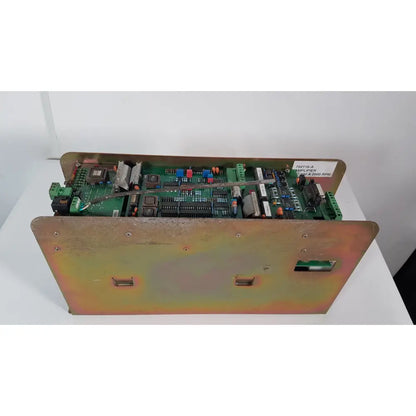Green circuit board in rust-toned metal enclosure with screws and labels of bystronic 702116-a amplifier 100 a 2000 rpm