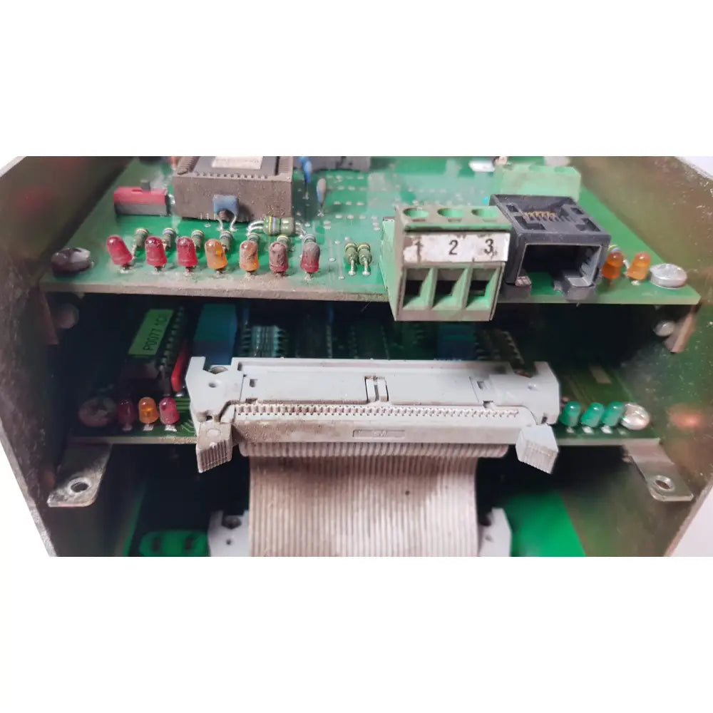 Gray plastic connector with ribbon cable on green circuit boards inside bystronic 702116-a amplifier enclosure