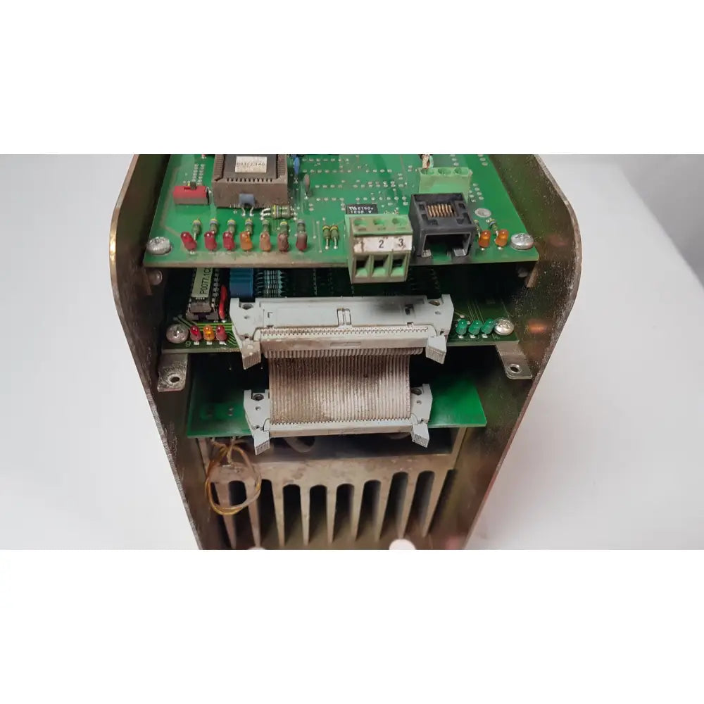 Weathered brass enclosure housing a green circuit board with connectors in a bystronic 702116-a amplifier product