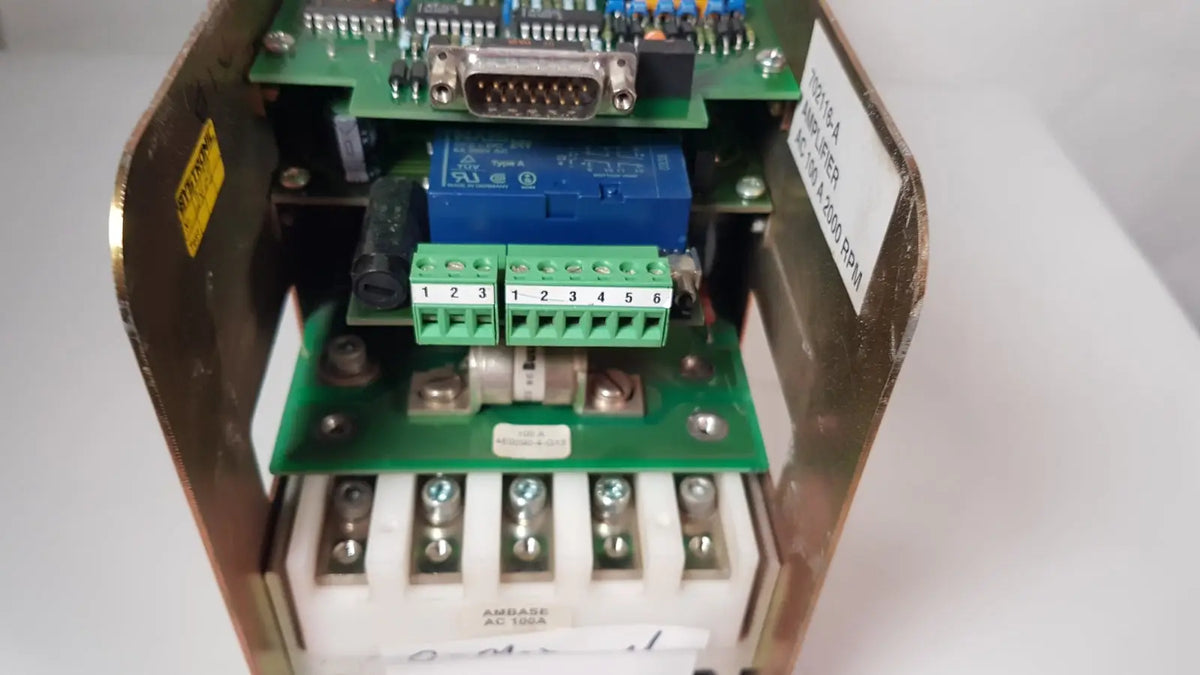 Blue bystronic 702116-a amplifier with green terminal blocks and silver d-sub connector in open metal enclosure