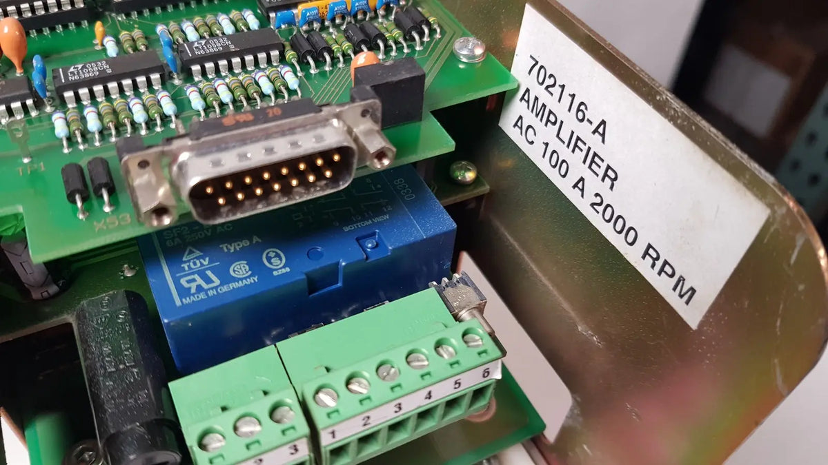 Blue relay switch with green terminal blocks and silver d-sub connector on circuit board of bystronic 702116-a amplifier