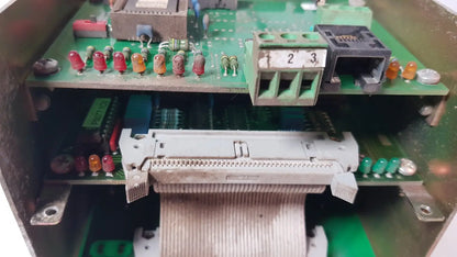 Gray plastic connector with ribbon cable on green circuit boards inside bystronic 702116-a amplifier enclosure
