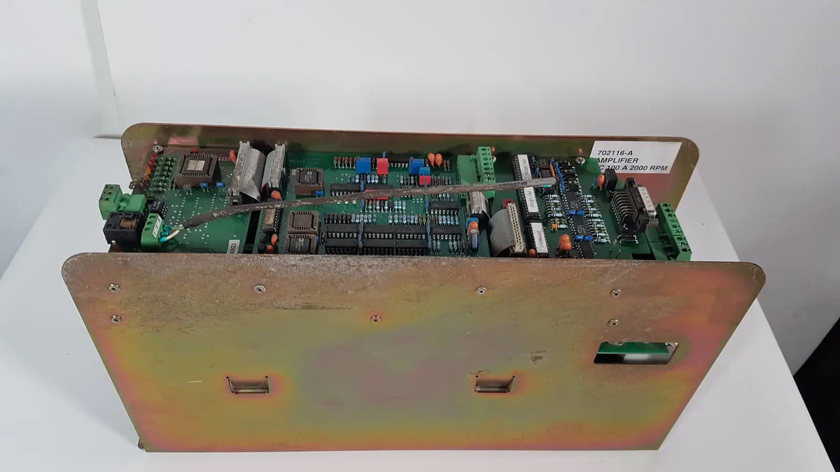 Green circuit board in rust-toned metal enclosure with screws and labels of bystronic 702116-a amplifier 100 a 2000 rpm