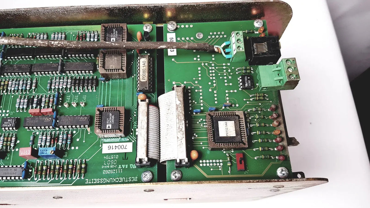 Green printed circuit board with black integrated circuits and connectors in bystronic 702116-a amplifier product