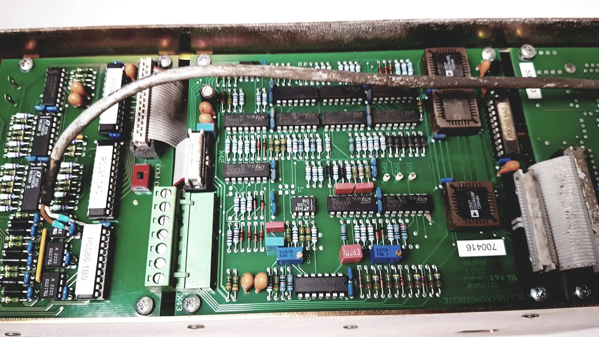 Green printed circuit board with electronic components and silver cable of bystronic 702116-a amplifier ac 100 a 2000 rpm