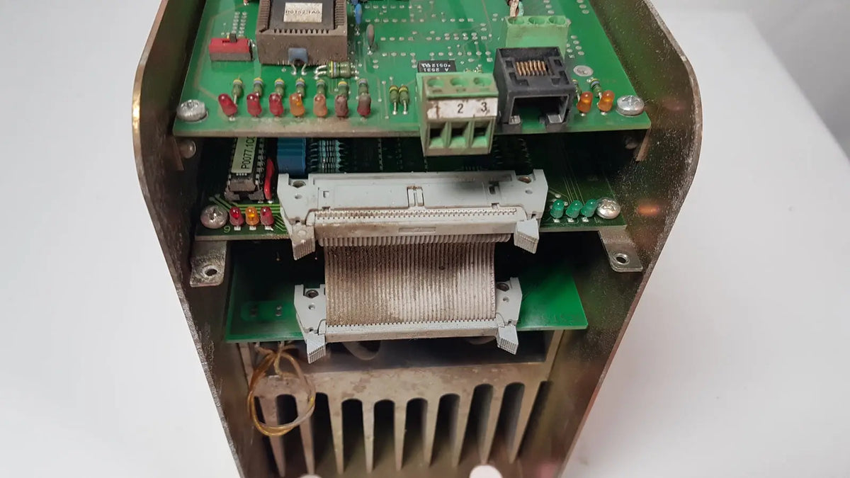 Weathered brass enclosure housing a green circuit board with connectors in a bystronic 702116-a amplifier product