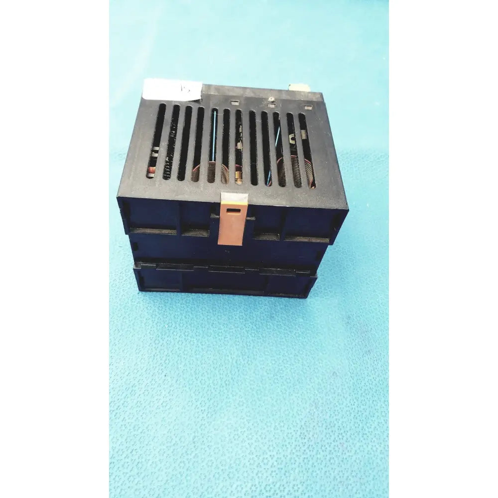 Black plastic Bystronic modul input output module with beige latch and vertical ventilation slots for industrial use