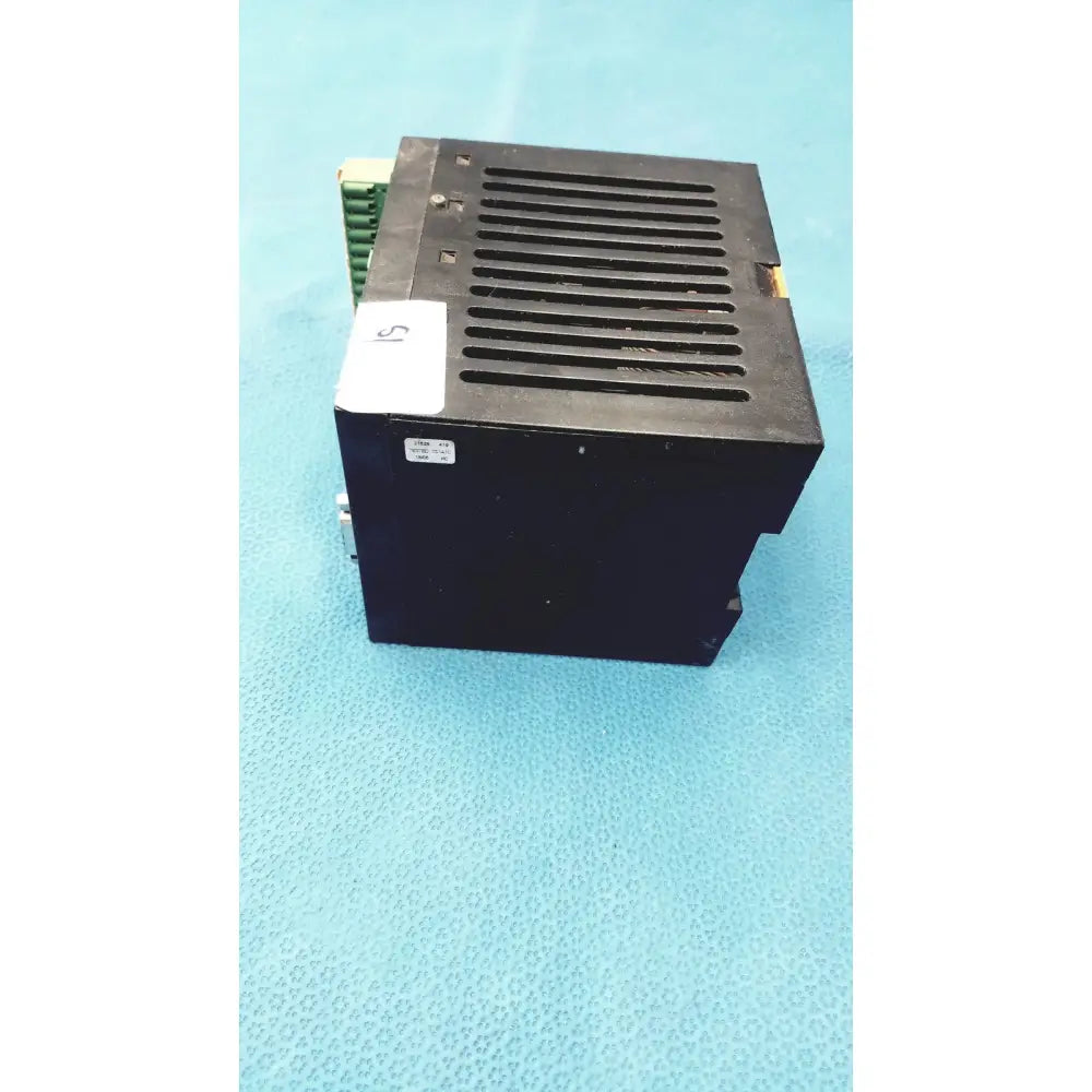 Black rectangular Bystronic modul input output unit with vented top and green terminal block on the side