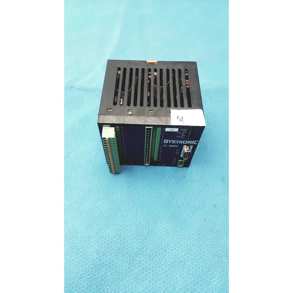 Black bystronic modul input output module with green terminal blocks and vented top for industrial control use
