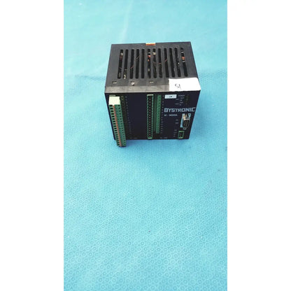 Black bystronic input output module with green terminal blocks and ventilation grille for industrial control applications