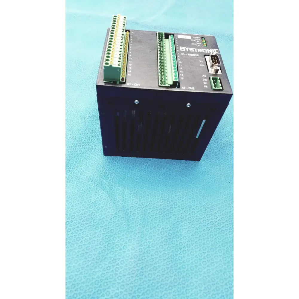 Black Bystronic I/O modul input output module with green terminal blocks and labeled ports for industrial use