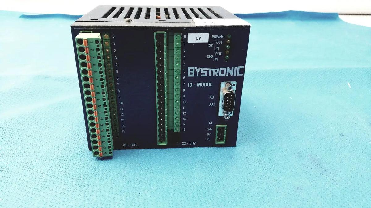 Black bystronic io-modul input output module with green terminal blocks and db9 serial port for industrial control