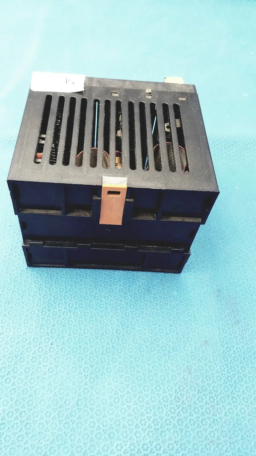 Black plastic Bystronic modul input output module with beige latch and vertical ventilation slots for industrial use