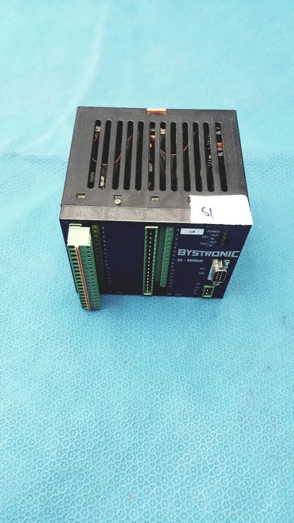 Black bystronic modul input output module with green terminal blocks and vented top for industrial control use
