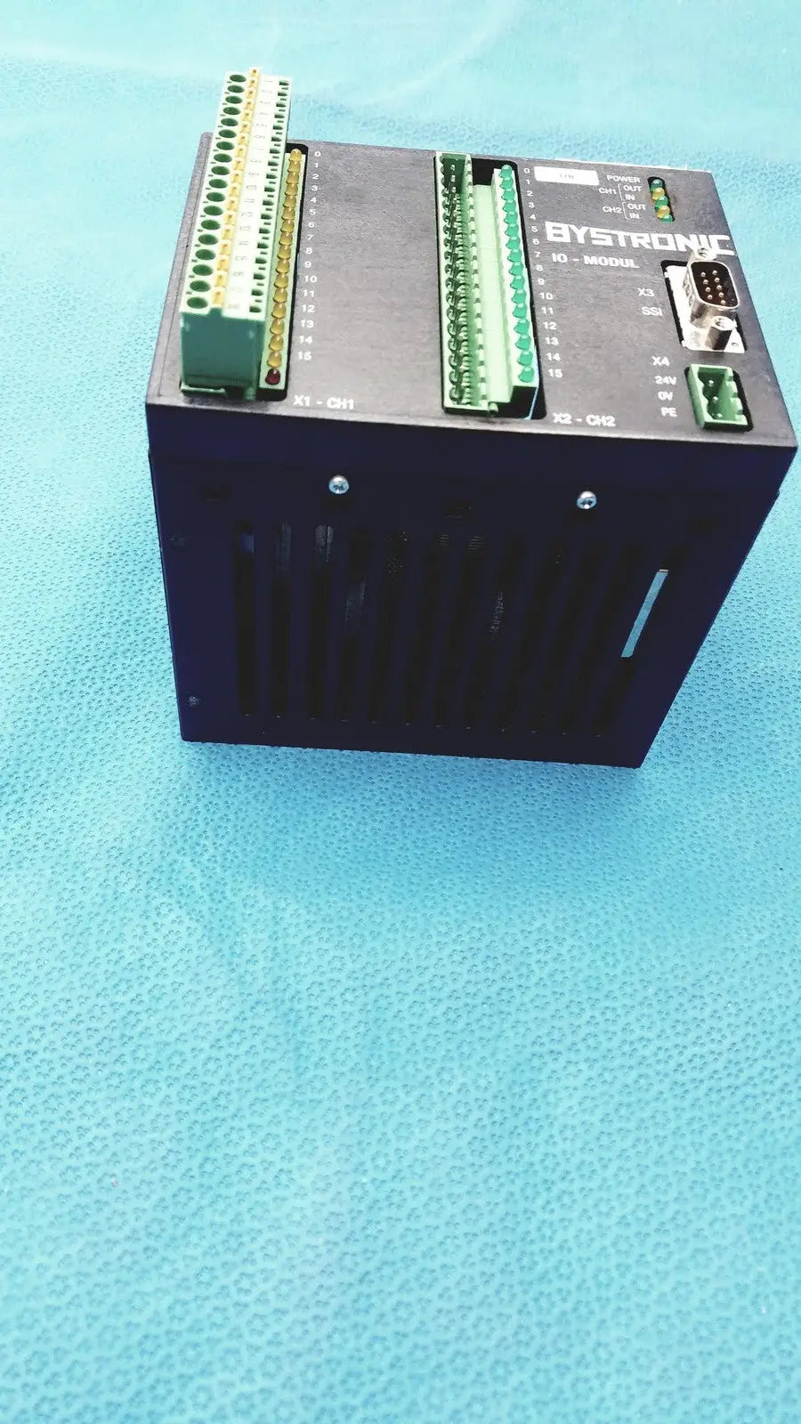 Black Bystronic I/O modul input output module with green terminal blocks and labeled ports for industrial use